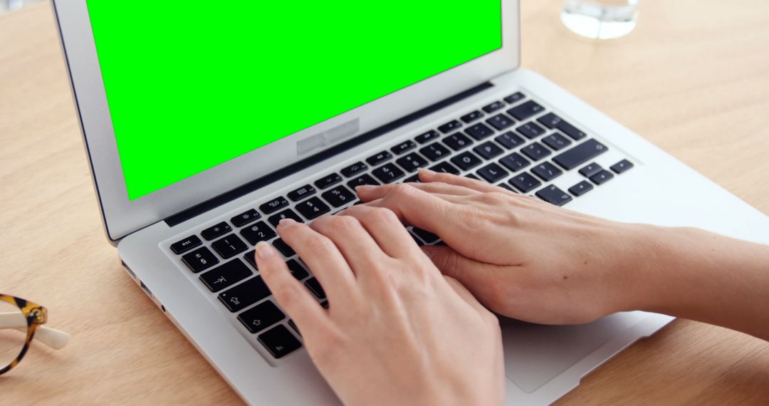 Person Typing on Laptop with Green Screen on Desk - Free Images, Stock Photos and Pictures on Pikwizard.com