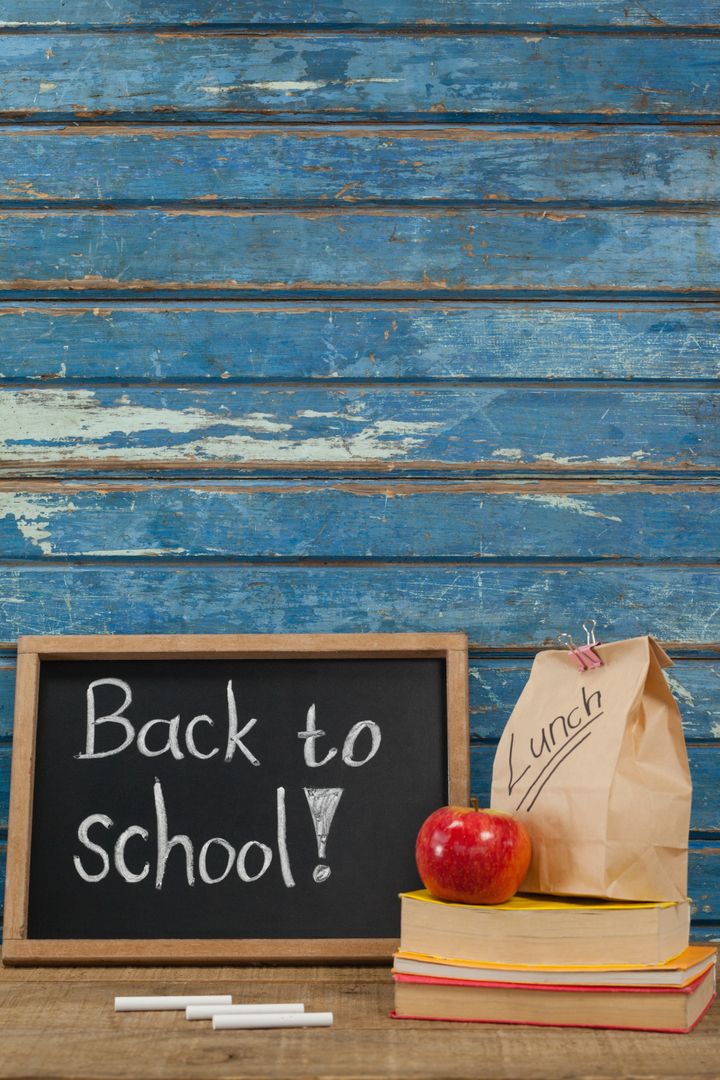 Back to School Concept with Apple, Lunch Bag, Books, and Slate - Free Images, Stock Photos and Pictures on Pikwizard.com