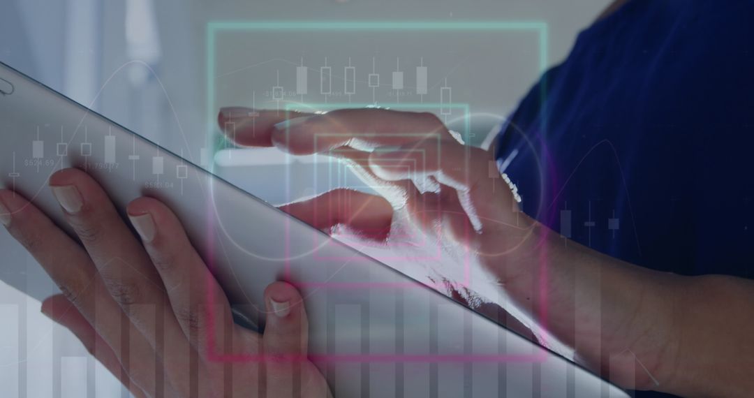 Hands Tapping Tablet with Financial Graph Overlays in Business Environment