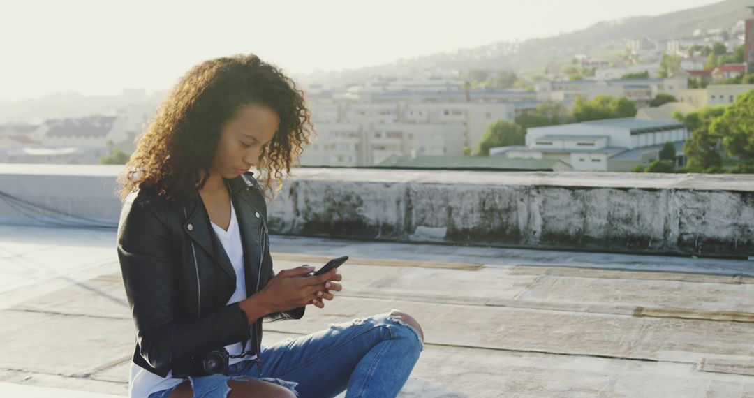 Woman Sitting on Rooftop Using Smartphone - Free Images, Stock Photos and Pictures on Pikwizard.com