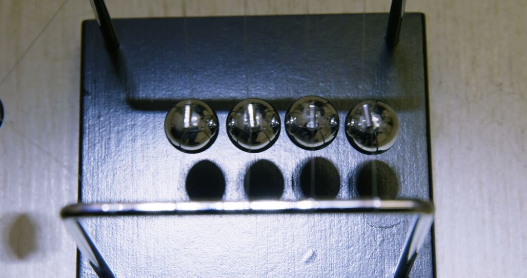 Close-Up of Newton's Cradle Pendulum in Motion - Free Images, Stock Photos and Pictures on Pikwizard.com