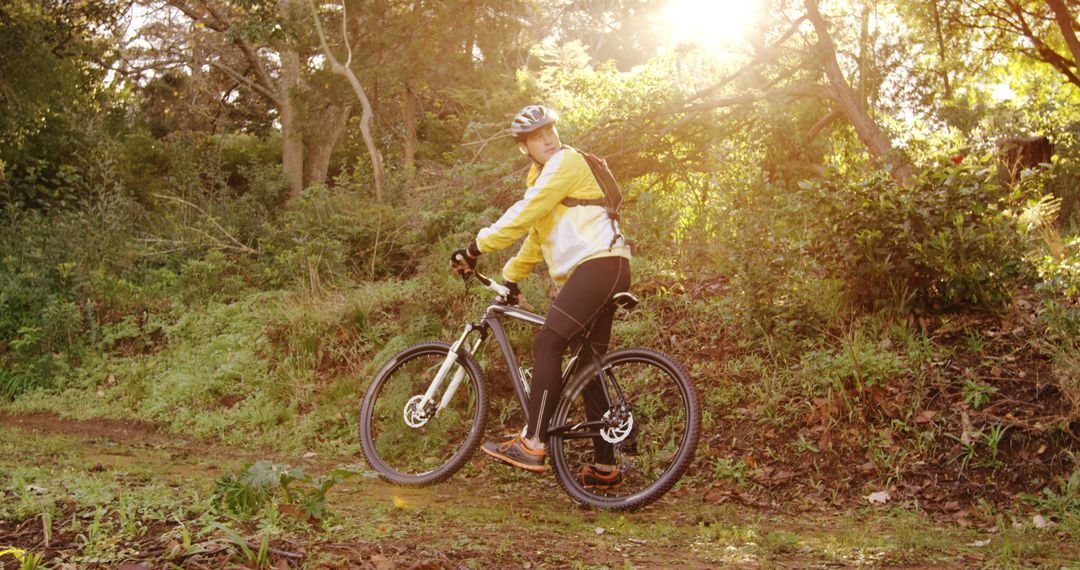 Mountain Biker Riding through Forest Trail at Sunset - Free Images, Stock Photos and Pictures on Pikwizard.com