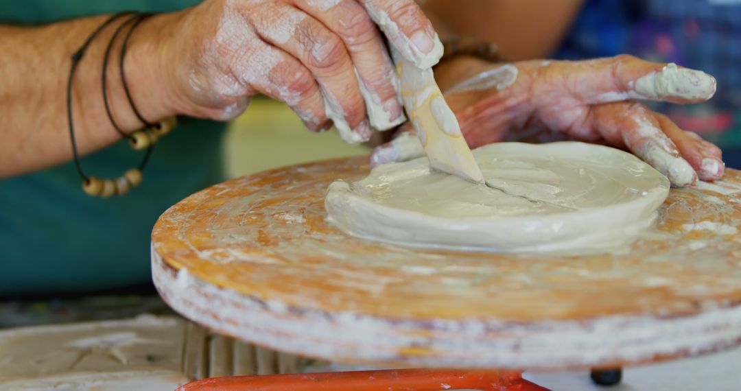 Close-up of potter shaping clay on pottery wheel during workshop - Free Images, Stock Photos and Pictures on Pikwizard.com