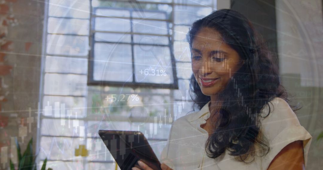 Smiling Businesswoman Analyzing Financial Graphs with Tablet
