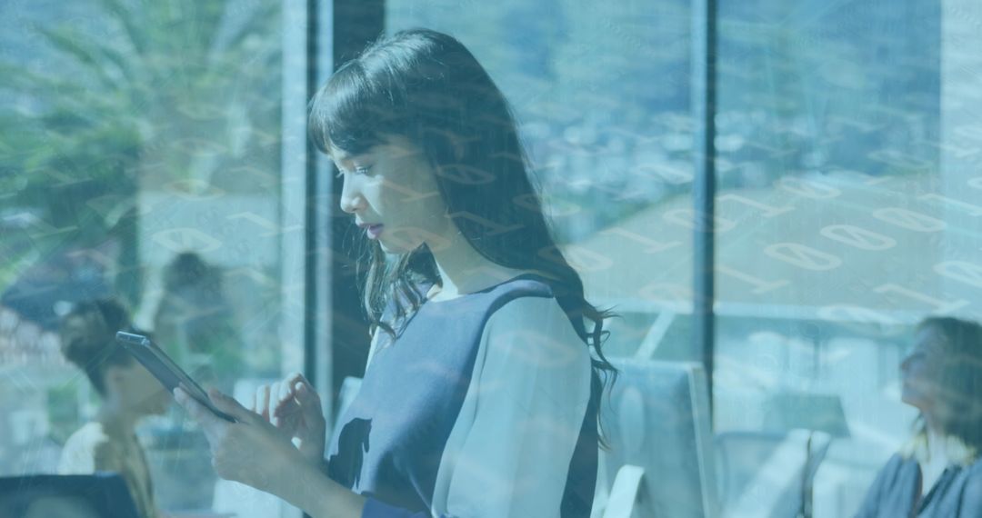 Businesswoman Analyzing Data on Tablet During Work Meeting