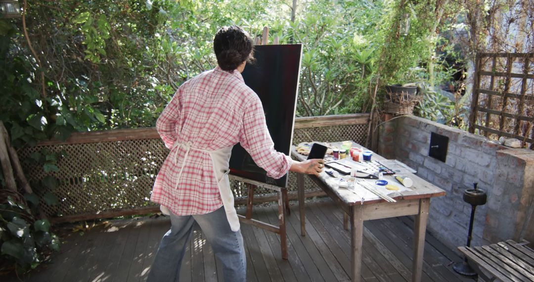 Artist Painting on Deck in Garden Studio - Free Images, Stock Photos and Pictures on Pikwizard.com