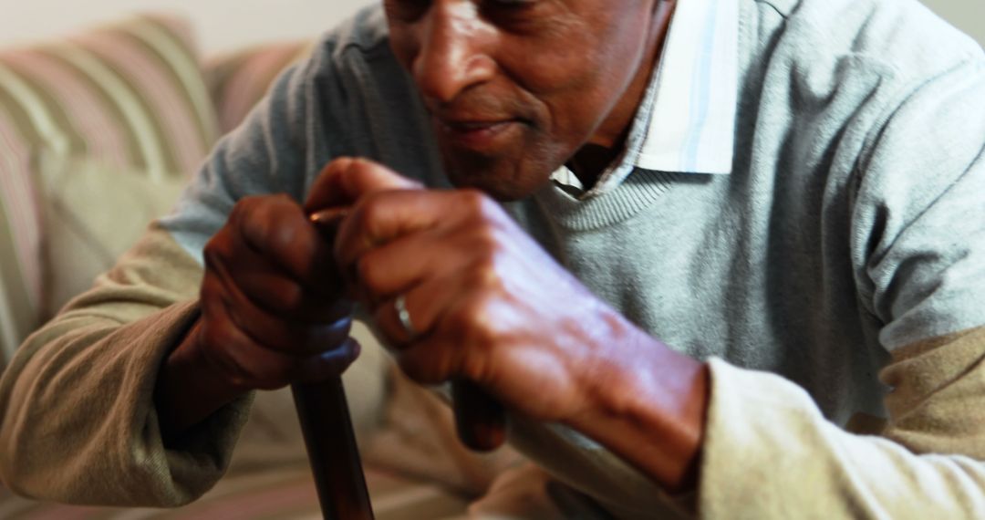 Senior Man Holding Walking Cane at Home on Couch - Free Images, Stock Photos and Pictures on Pikwizard.com