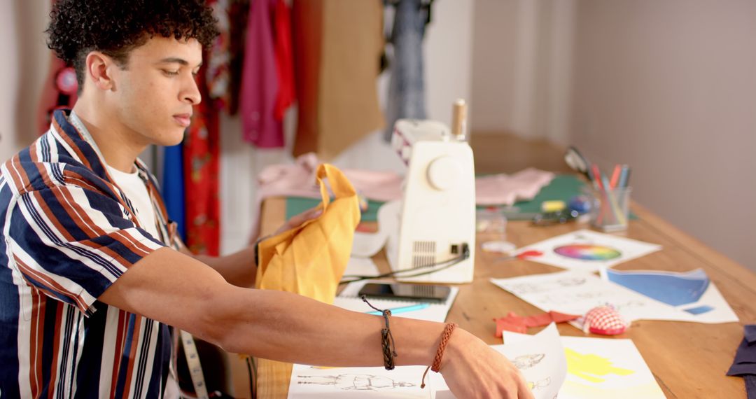 Young Man Sewing at Home with Sewing Machine and Fabric Samples - Free Images, Stock Photos and Pictures on Pikwizard.com