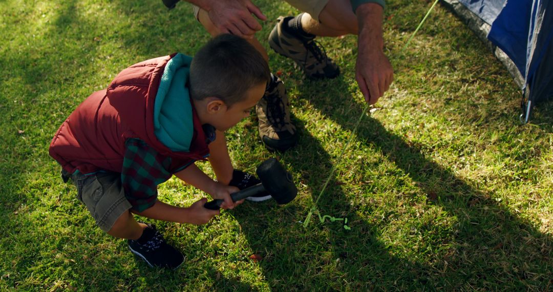 Father and Son Setting Up Tent on Grass - Free Images, Stock Photos and Pictures on Pikwizard.com