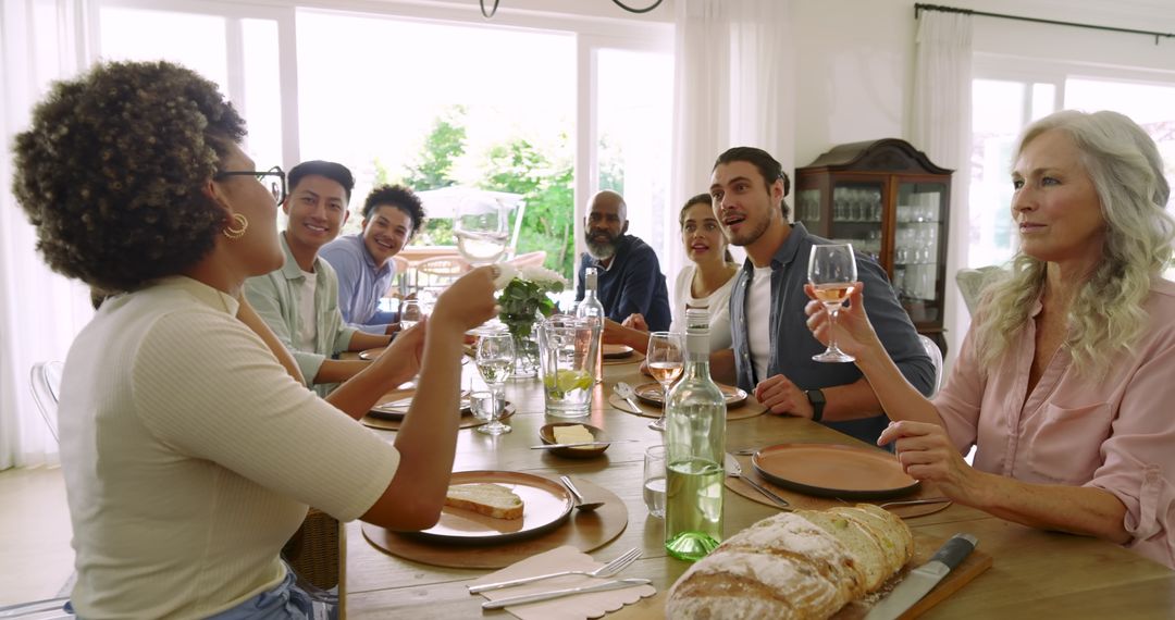 Diverse Group of Friends Laughing and Sharing Lunch at Dining Table