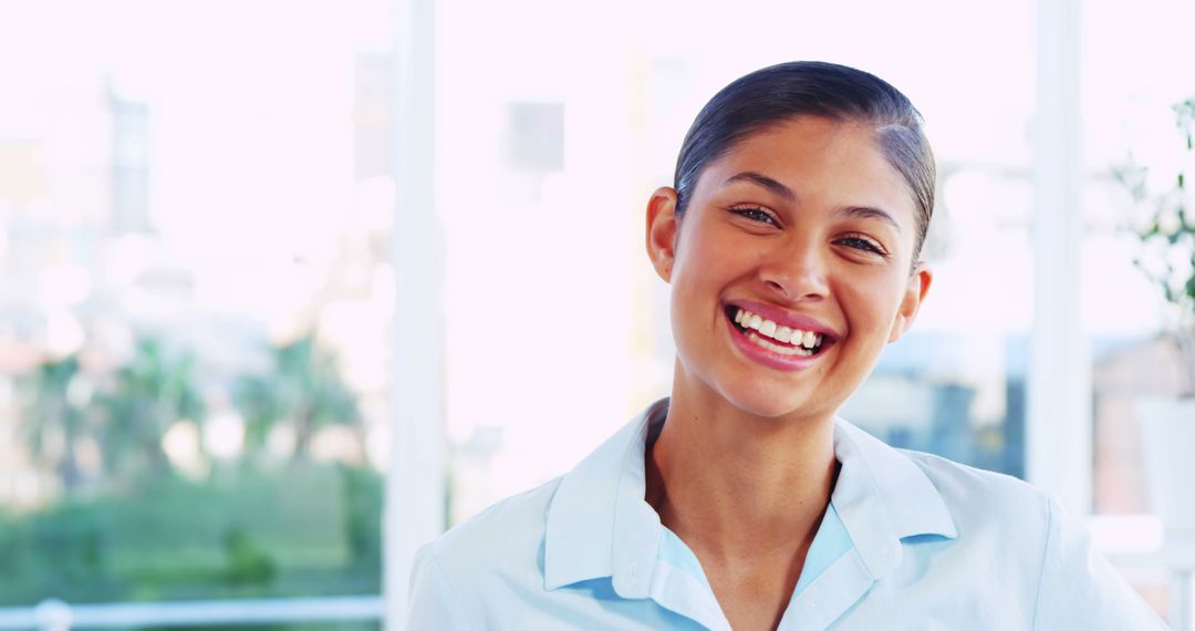 Smiling Young Woman in Professional Attire with Bright Background - Free Images, Stock Photos and Pictures on Pikwizard.com