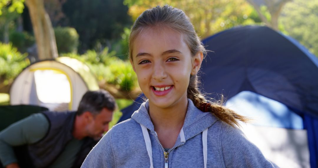 Young Girl Smiling at Camping Site with Tent Setup - Free Images, Stock Photos and Pictures on Pikwizard.com