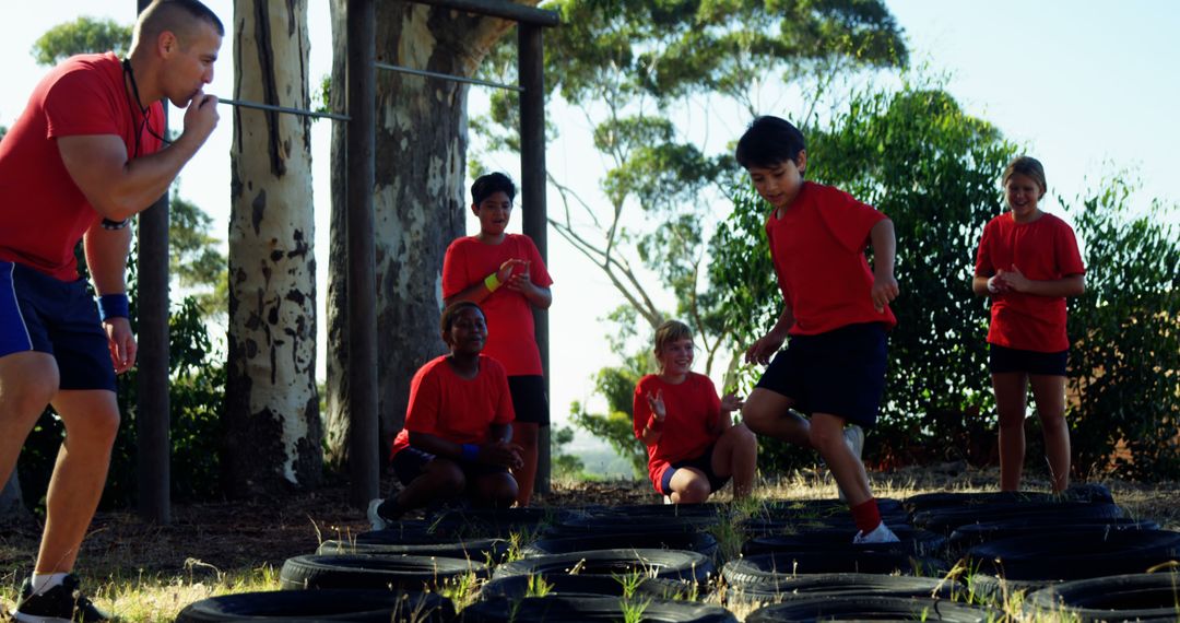 Children Participating in Outdoor Obstacle Course with Instructor - Free Images, Stock Photos and Pictures on Pikwizard.com