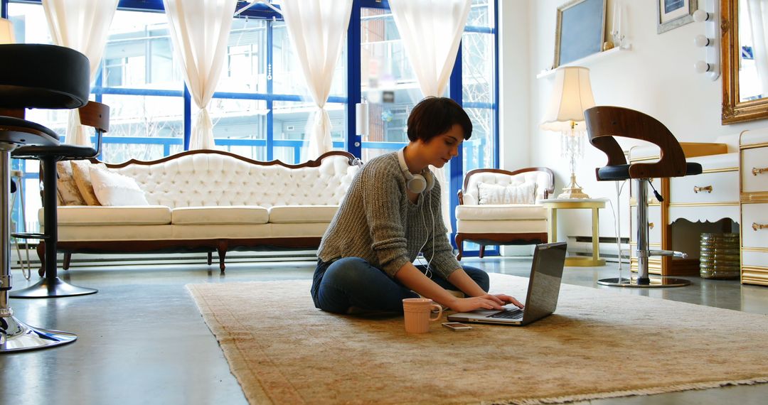 Young Woman Working on Laptop in Cozy Modern Living Room - Free Images, Stock Photos and Pictures on Pikwizard.com