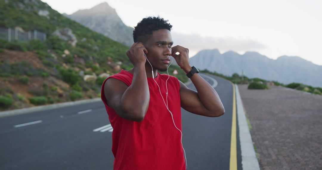 Athletic Man Preparing for Outdoor Workout Wearing Earphones - Free Images, Stock Photos and Pictures on Pikwizard.com