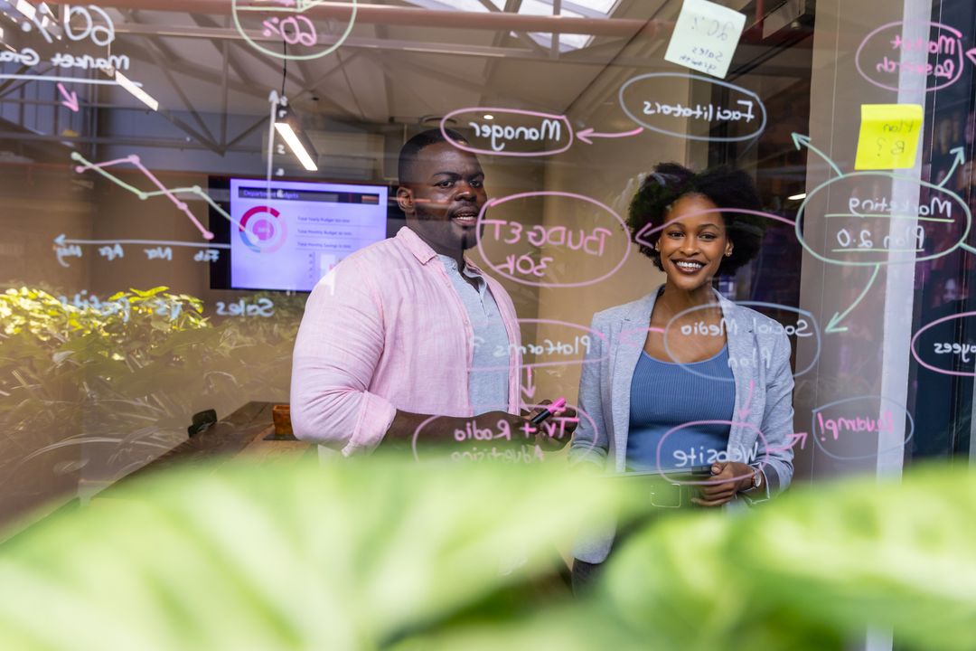 Innovative Team Brainstorming Session with Glass Board