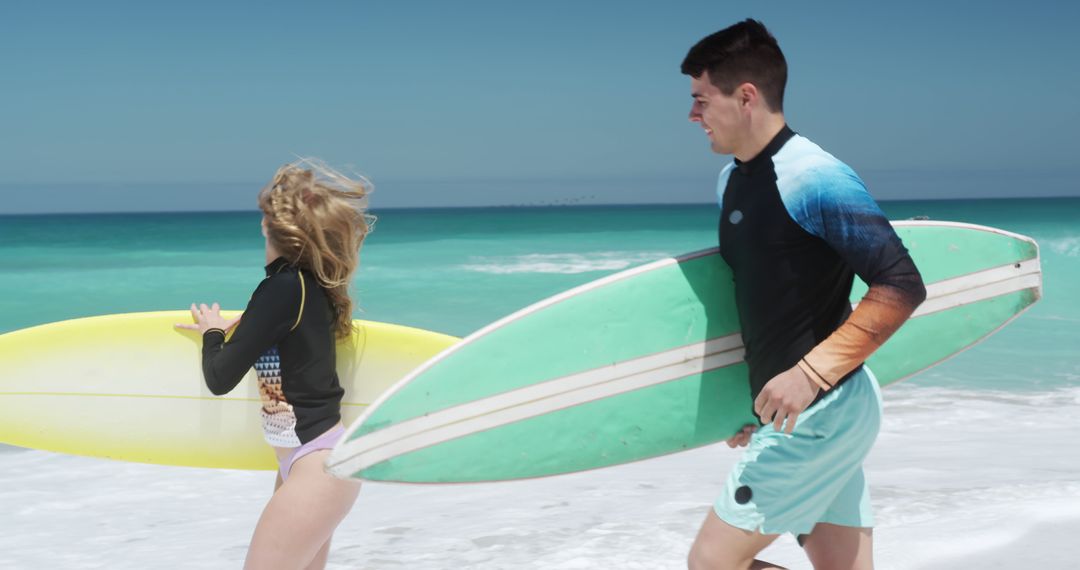 Young Surfers Preparing to Enter Ocean on Sunny Beach Day - Free Images, Stock Photos and Pictures on Pikwizard.com