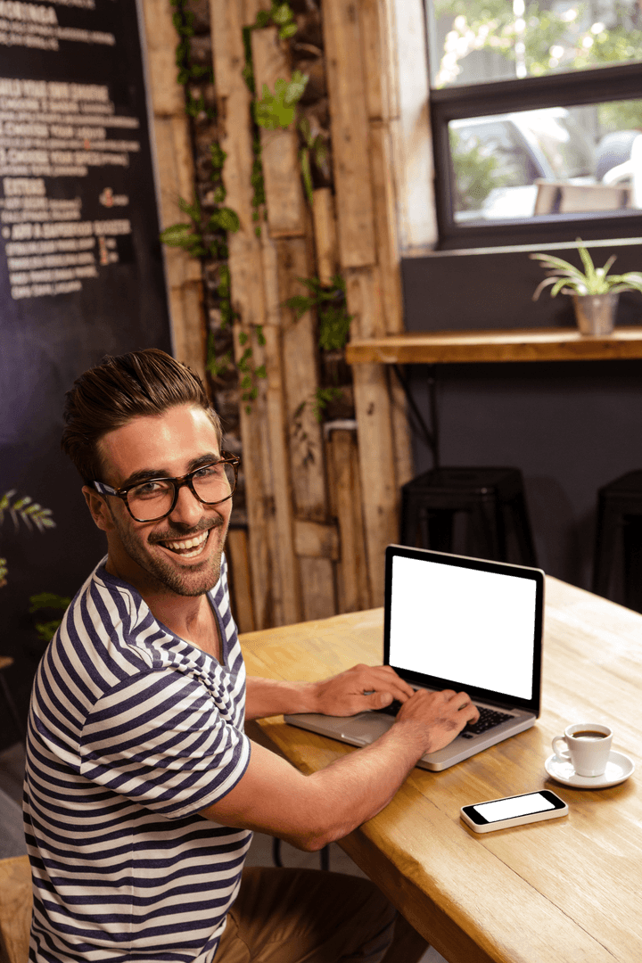 Bearded Man with Glasses in Cafe Using Laptop