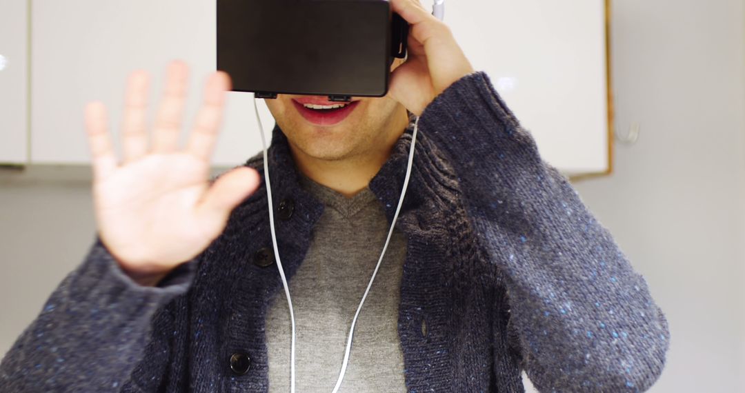 Man Using Virtual Reality Headset Enjoying VR Experience - Free Images, Stock Photos and Pictures on Pikwizard.com