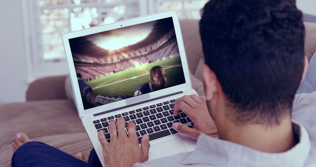 Man Watching Football Game on Laptop at Home Living Room - Free Images, Stock Photos and Pictures on Pikwizard.com