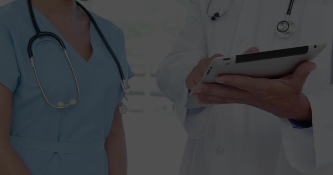 Medical Team Consulting on Tablet in Clinic Reviewing Digital Patient Records and Charts