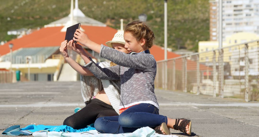 Young Girls Taking Selfie Outdoors with Tablet - Free Images, Stock Photos and Pictures on Pikwizard.com