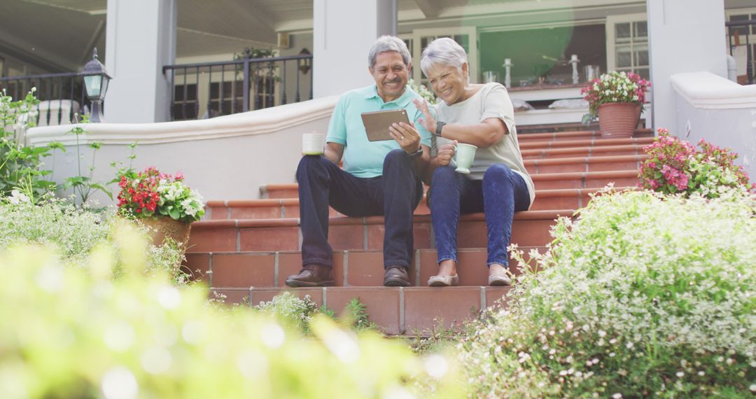 Image of happy biracial senior couple using tablet in garden - Free Images, Stock Photos and Pictures on Pikwizard.com