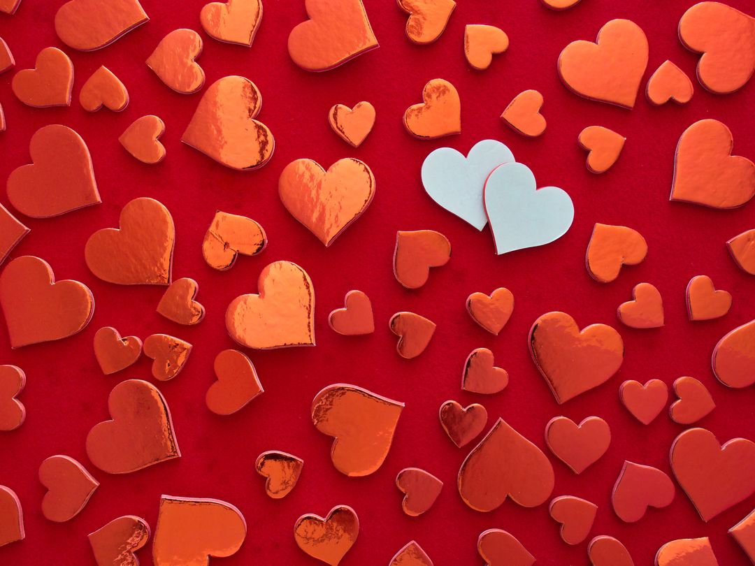 Scattered Red Hearts on Vibrant Red Background