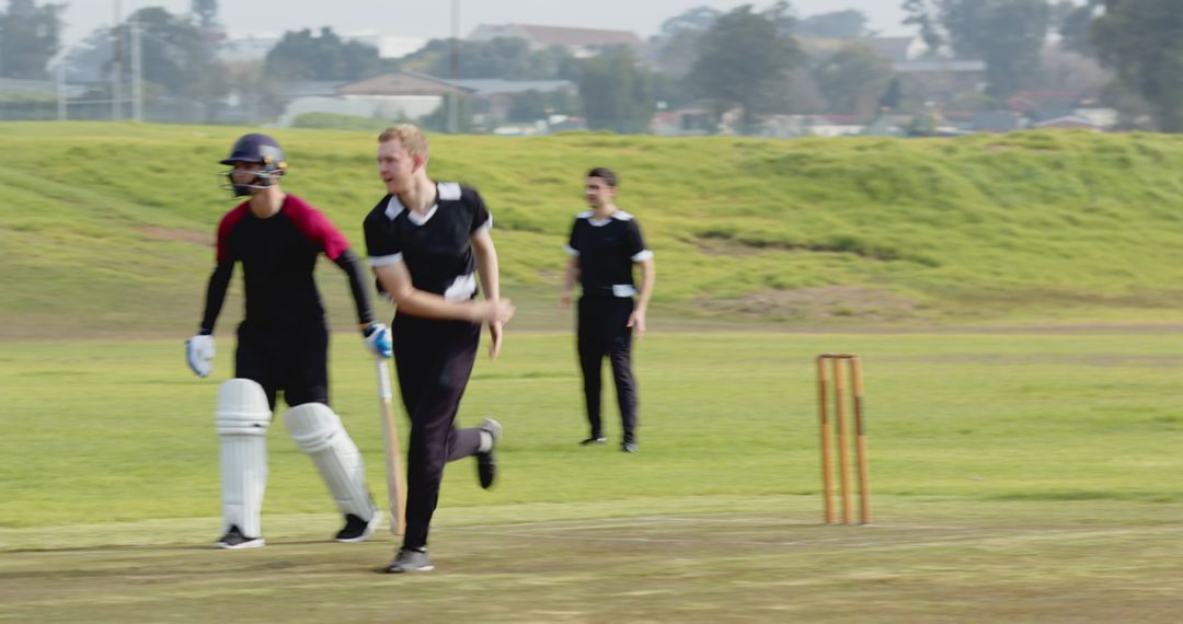 Cricketers in Action on Field During Match Competition Game