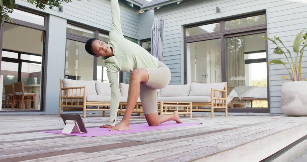 Young Woman Practicing Yoga on Patio with Tablet Guidance - Free Images, Stock Photos and Pictures on Pikwizard.com