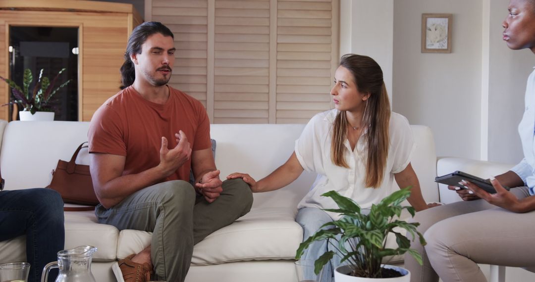 Diverse Group Engaging in Thoughtful Conversation on Comfortable Sofa