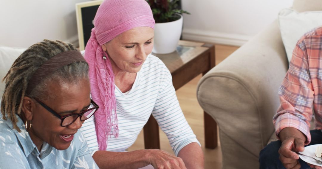 Senior Friends Enjoying Time Together at Home Laughing and Sharing