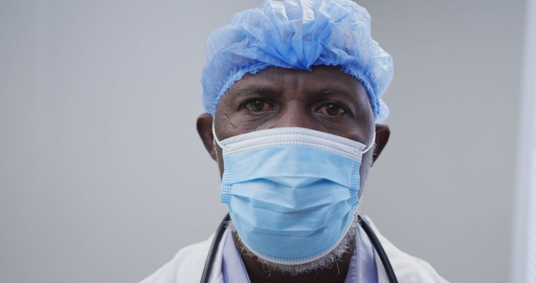 Portrait of african american male doctor wearing face mask and surgical cap - Free Images, Stock Photos and Pictures on Pikwizard.com