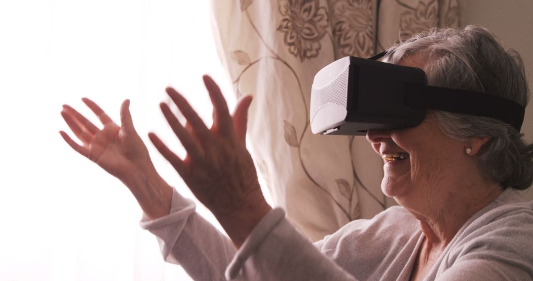 Excited Elderly Woman Using Virtual Reality Headset at Home - Free Images, Stock Photos and Pictures on Pikwizard.com