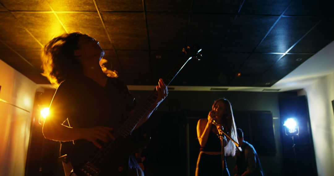 Rock Band Performing in Recording Studio with Vibrant Lighting