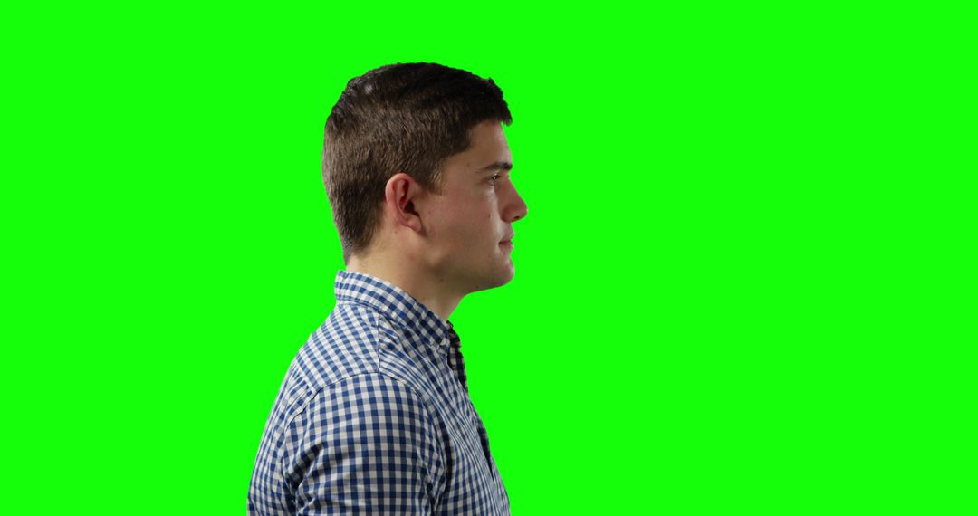 Profile of Young Man Against Green Screen for Background Replacement