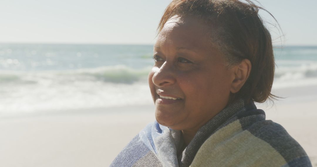 Senior Woman Smiling on Beach Enjoying Sunny Day - Free Images, Stock Photos and Pictures on Pikwizard.com