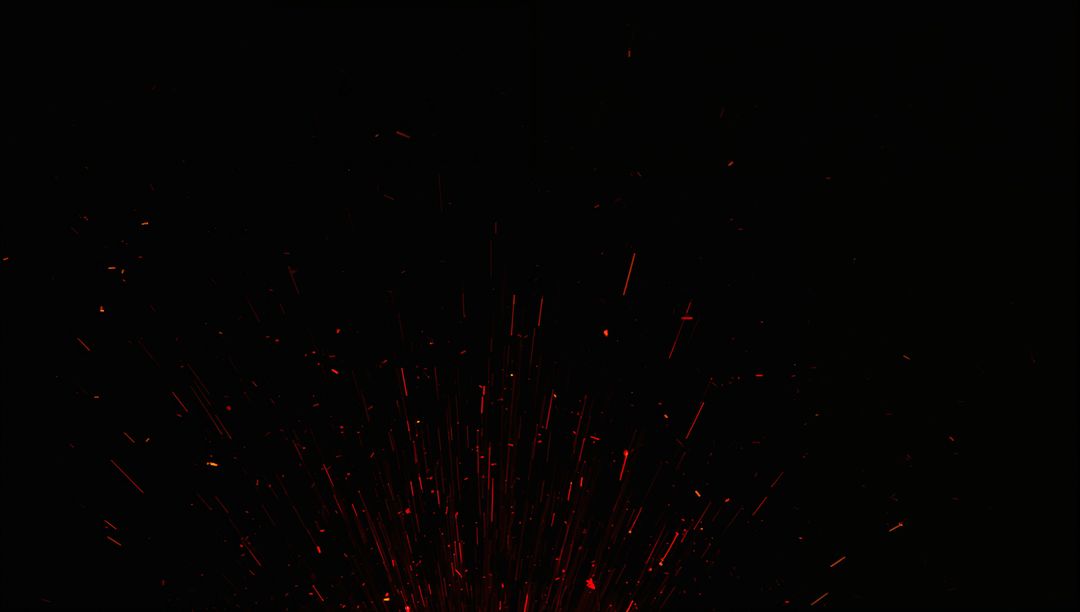 Red-Orange Sparks Radiating Upward with Streaking Ember Trails on Deep Black Background