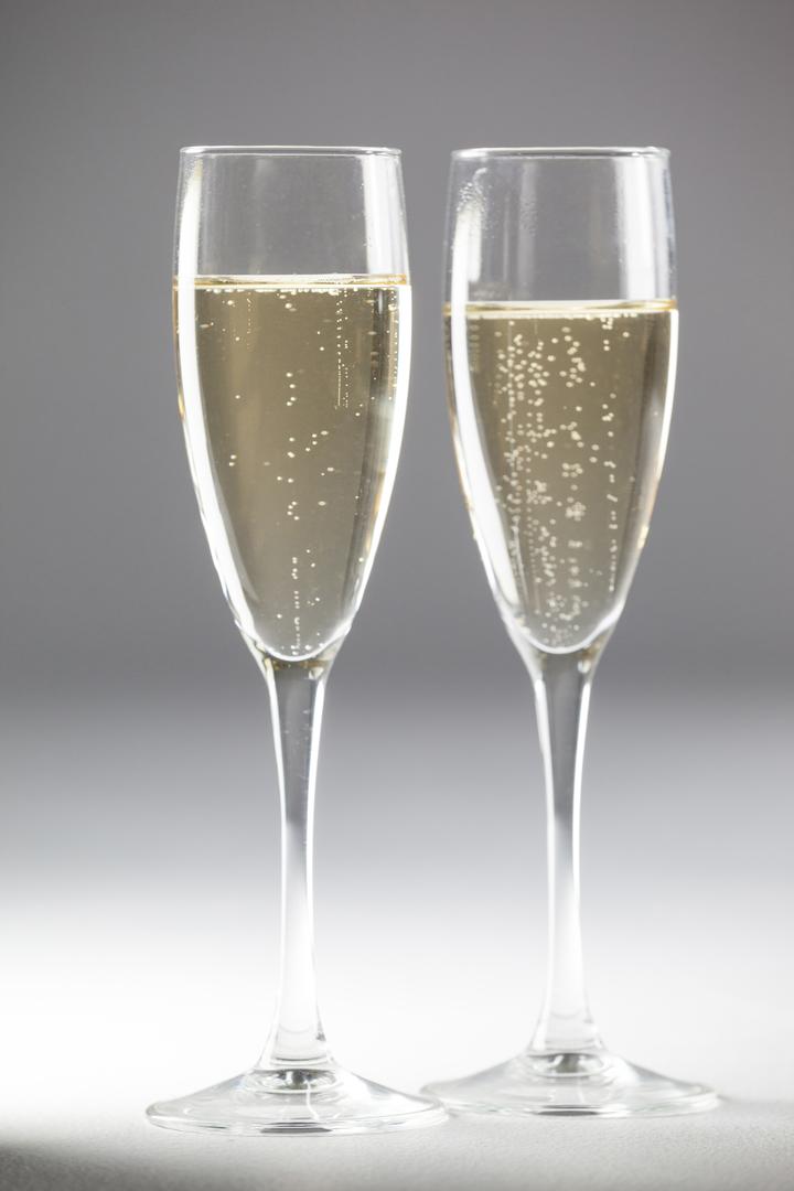 Close-Up of Two Champagne Flutes on White Background - Free Images, Stock Photos and Pictures on Pikwizard.com