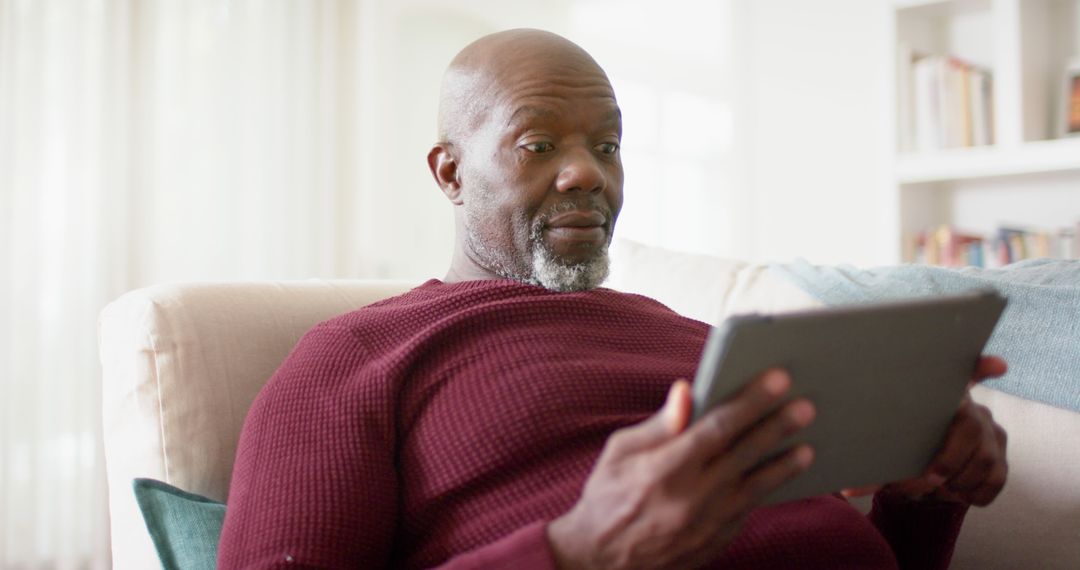 Middle Aged Man Using Tablet at Home - Free Images, Stock Photos and Pictures on Pikwizard.com