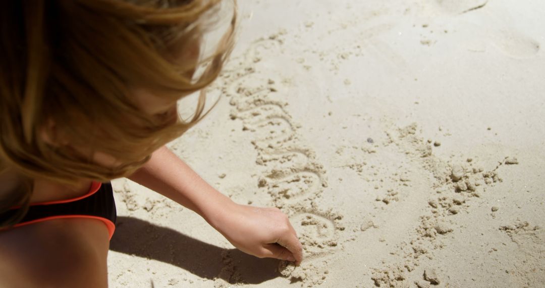 Child Writing in Sand on Beach - Free Images, Stock Photos and Pictures on Pikwizard.com