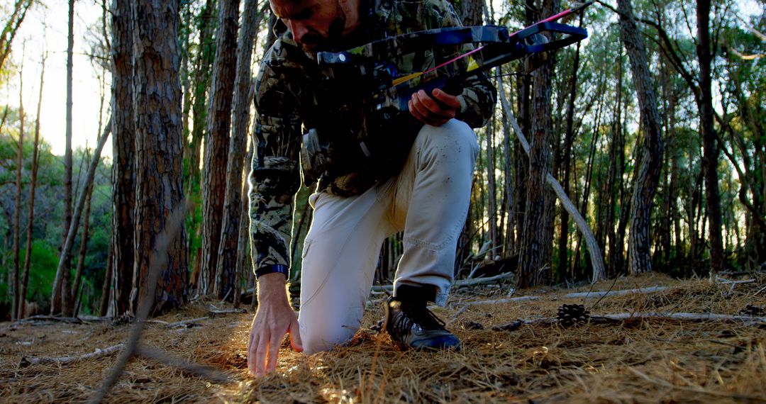 Hunter Tracking Deer Trail in Forest at Dusk - Free Images, Stock Photos and Pictures on Pikwizard.com