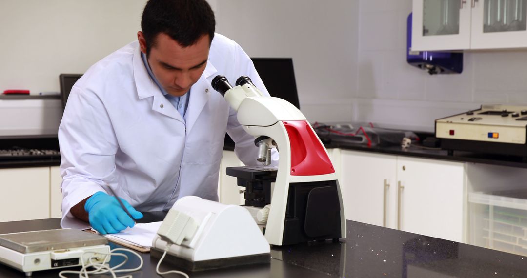 Male Scientist Conducting Research in Modern Laboratory with Microscope - Free Images, Stock Photos and Pictures on Pikwizard.com