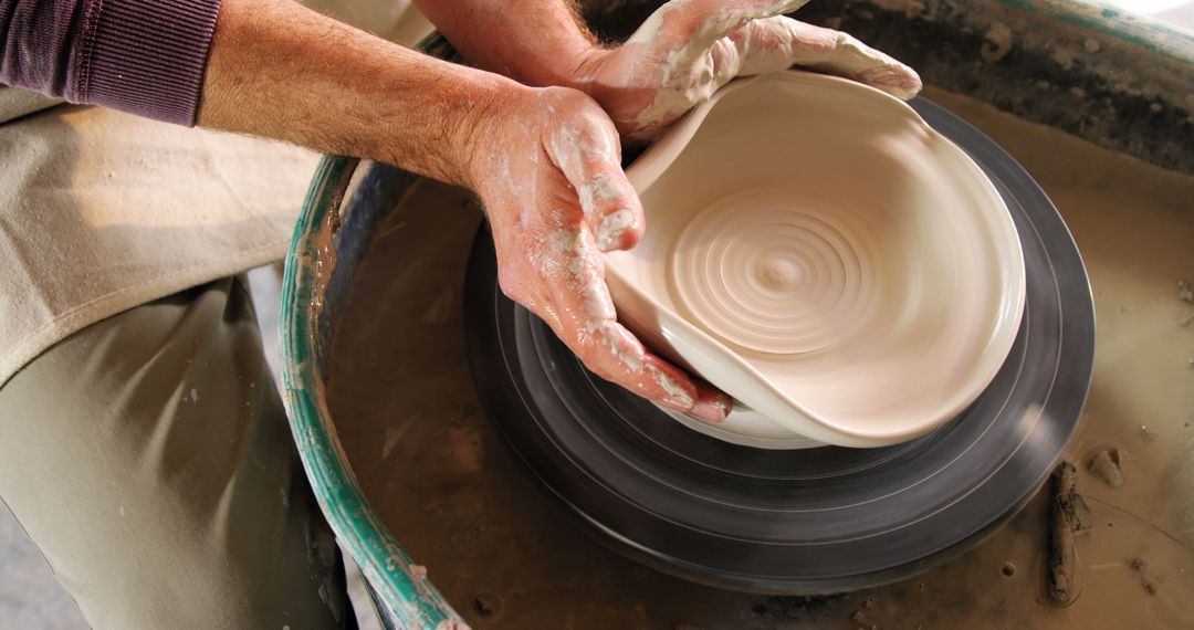 Potter Shaping Clay on Spinning Wheel, Closeup of Hands Creating Ceramic Bowl - Free Images, Stock Photos and Pictures on Pikwizard.com