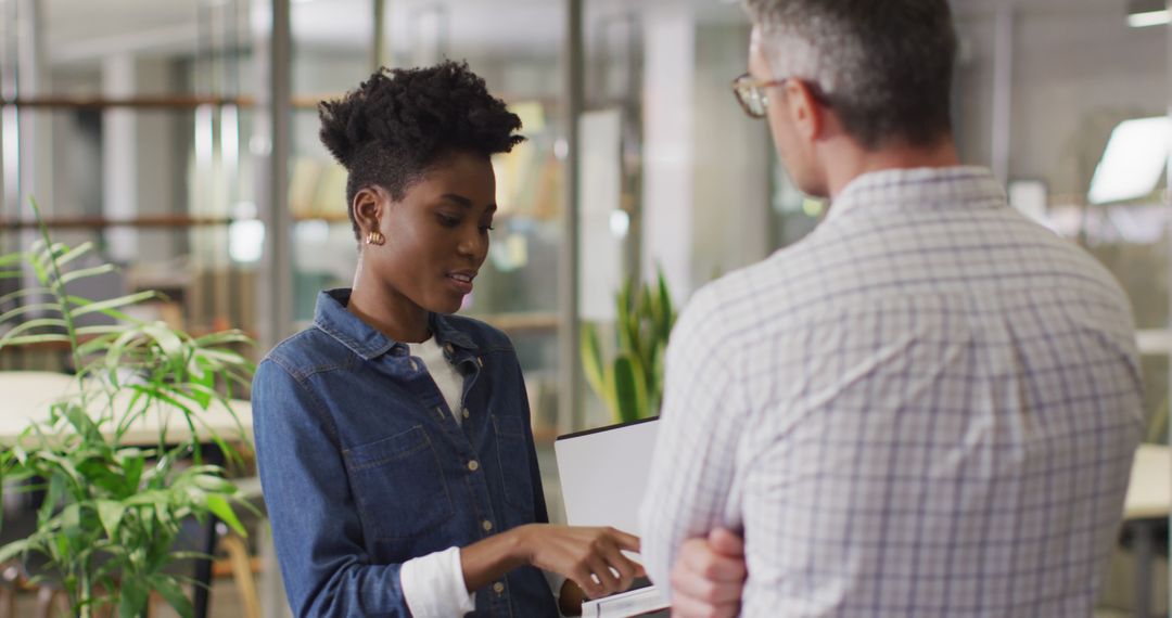 Professional Discussion Between Coworkers in Modern Office