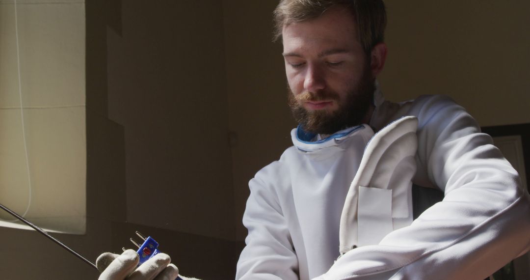 Focused Swordsman Preparing for Training in Practice Hall
