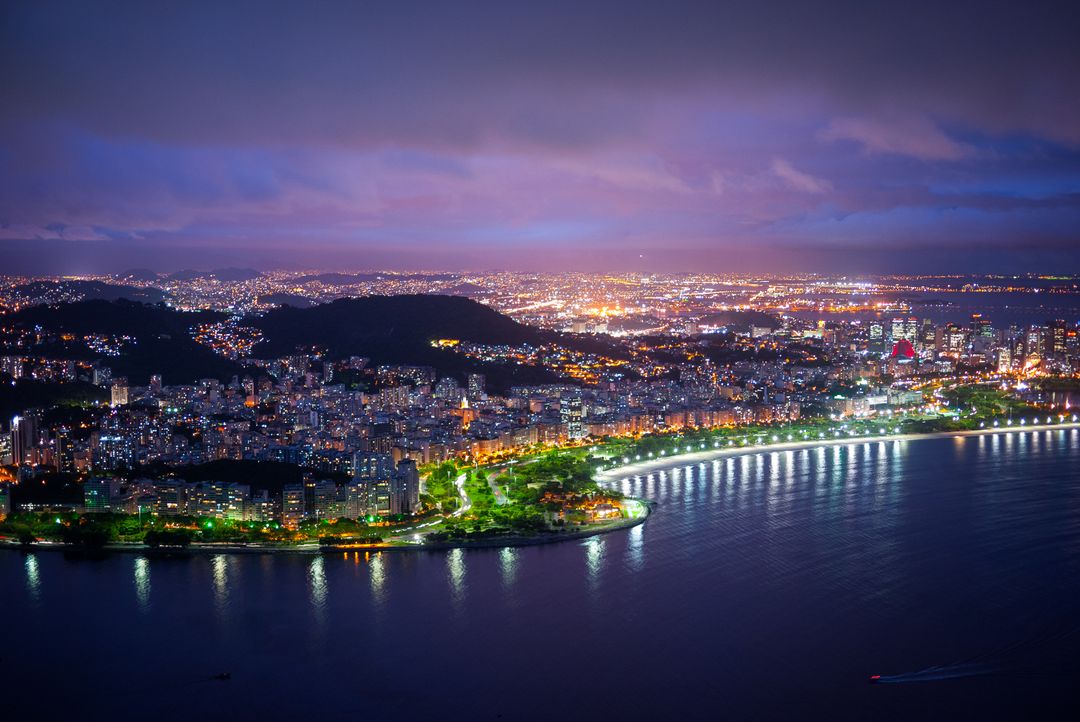 Panoramic Night View of Coastal Urban Skyline with Illuminated City Lights - Free Images, Stock Photos and Pictures on Pikwizard.com