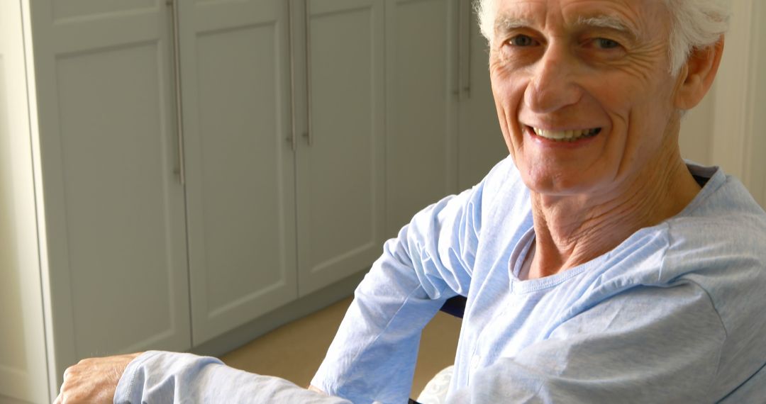 Elderly Man Smiling in Wheelchair Bathed in Natural Light - Free Images, Stock Photos and Pictures on Pikwizard.com