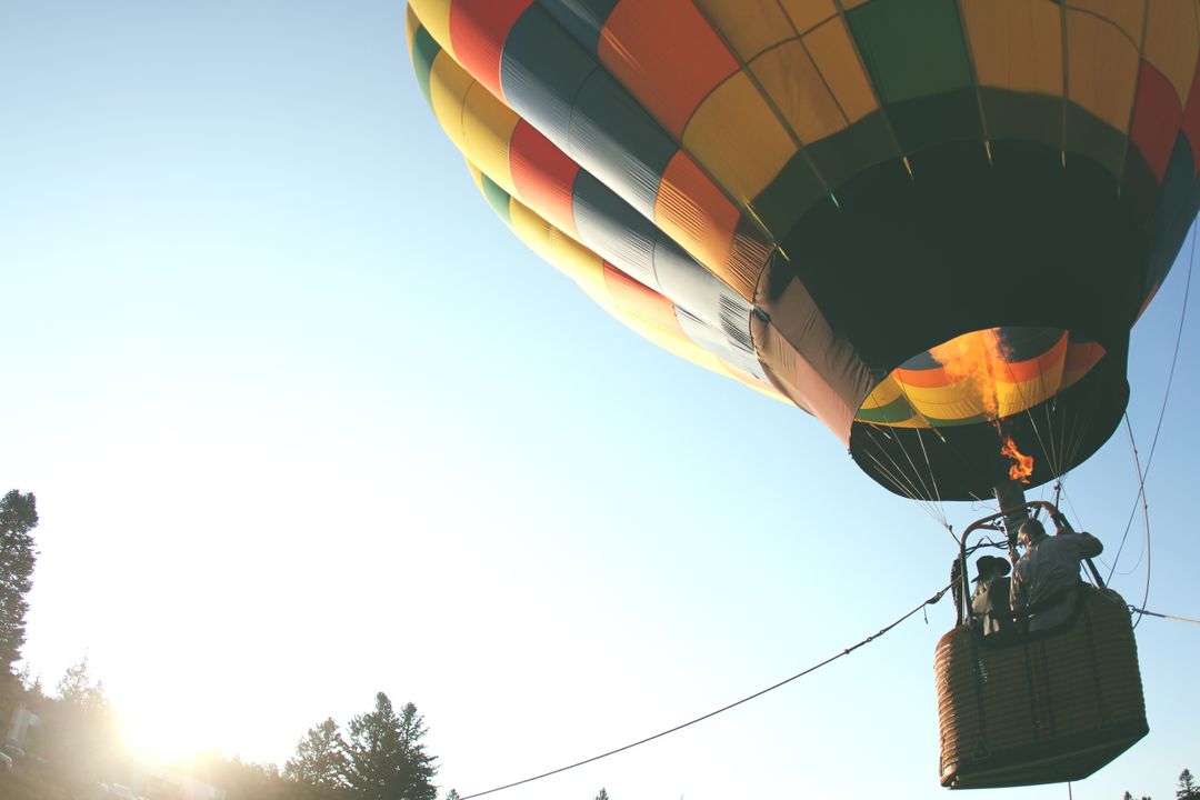Colorful Hot Air Balloon Ascends in Clear Sky at Sunrise - Free Images, Stock Photos and Pictures on Pikwizard.com