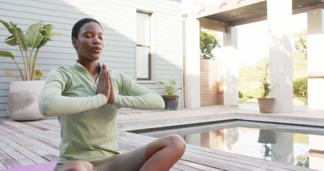 Young Woman Practicing Meditation by Poolside at Yoga Retreat - Free Images, Stock Photos and Pictures on Pikwizard.com